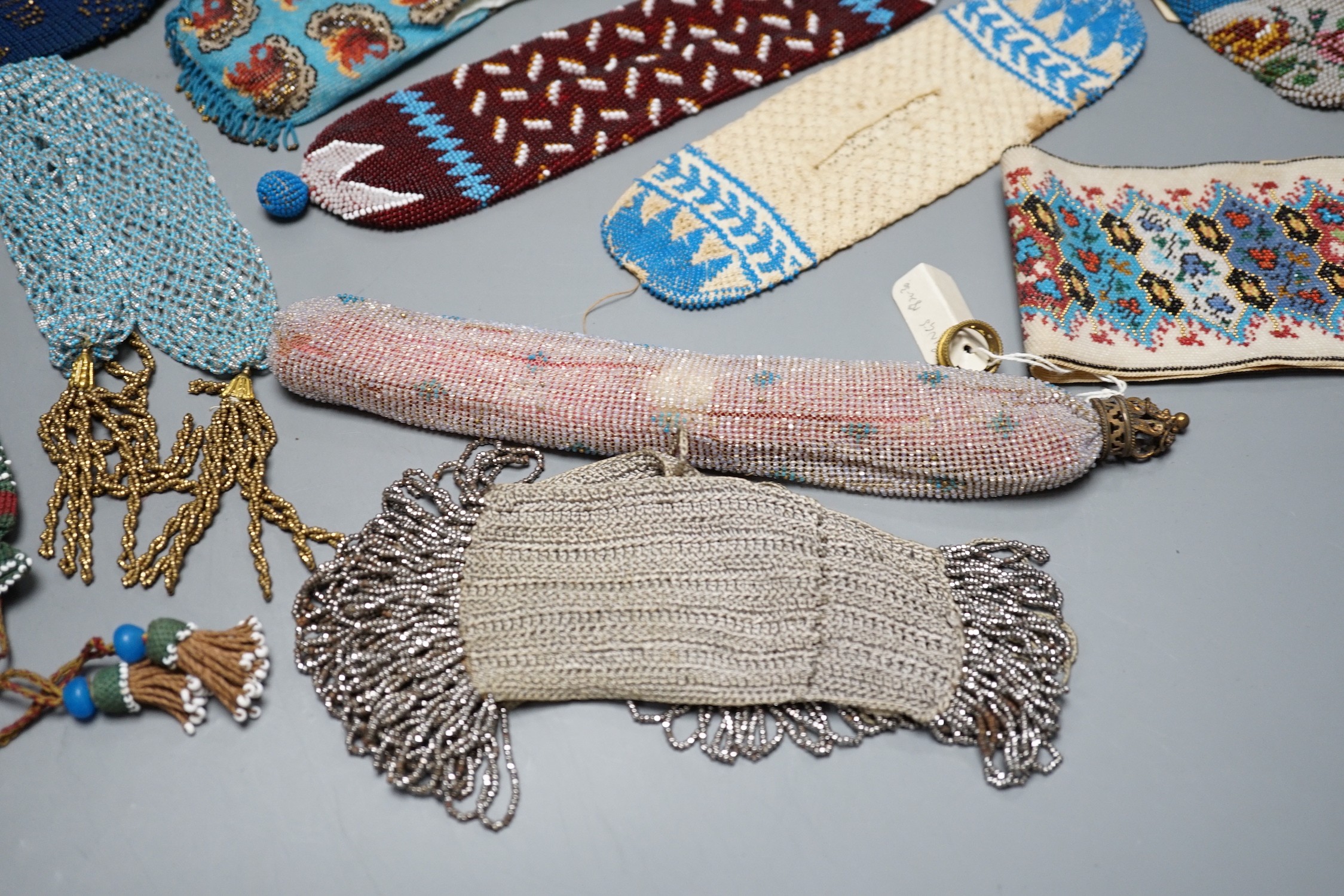 A collection of nine Berlin beadwork miser's purses and three panels, longest 26cm